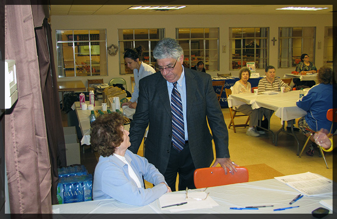 Senator Fontana speaks with Larene Walsh at the Senior Flu/Pneumonia Shot Clinic he hosted on October 24th at Church of the Resurrection in Brookline.