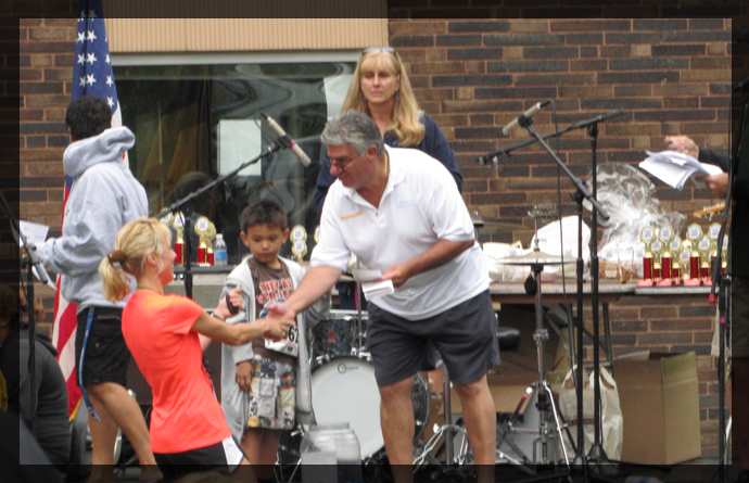 Senator Fontana hands out awards at the 31st Annual Brookline Breeze on Saturday, August 11th. 