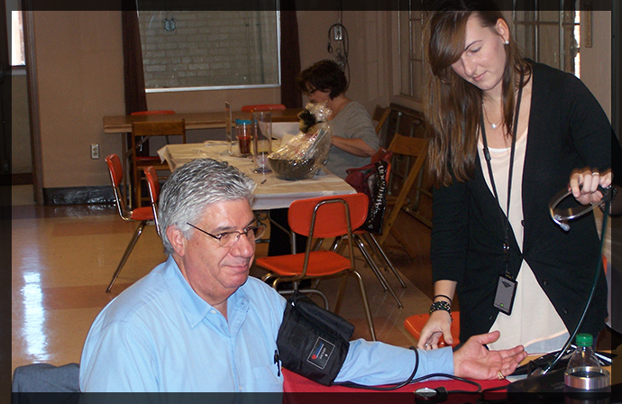 Kasey Malotte from the Duquesne University Mylan School of Pharmacy administers a blood pressure screening to Senator Fontana at the Senator?s Flu/Pneumonia Shot & Senior Clinic on September 27th, held at Church of the Resurrection in Brookline.